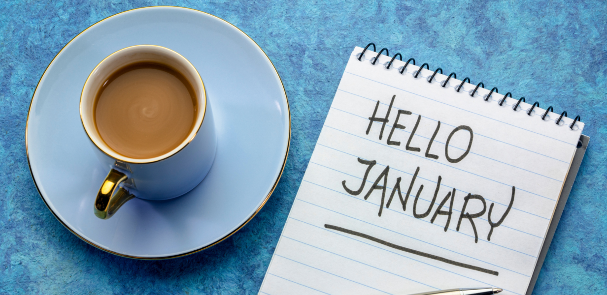 Tea cup and diary with a handwritten note saying hello January, symbolising new beginnings and hope