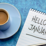Tea cup and diary with a handwritten note saying hello January, symbolising new beginnings and hope